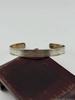 View of full bangle showing etched design on face