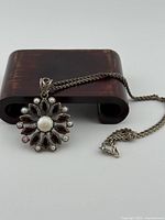 Pendant and chain on display stand