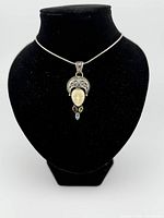 Pendant on chain displayed on bust