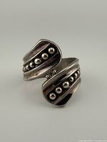 Front view showing overlapping cuff design and bead detailing