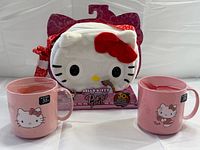 Front view of handbag in packaging with two mugs