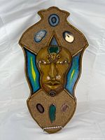 Front view of entire Egyptian-style mask plaque