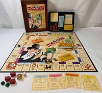 Overall view of open game showing board, slipcase box, components and cards