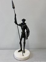 Full view of bronze Don Quixote statue on marble base
