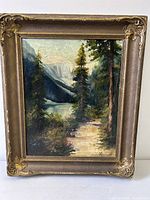 Frontal view of framed oil painting showing landscape and frame detail