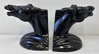 Frontal view of both horse head bookends showing overall design and finish