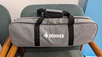 Front view of grey Donner carrying case
