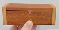 Front view of mahogany box with thumb-notch lid