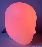 Lamp lit in pink showing head shape