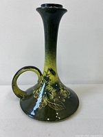 Front view showing full chamber stick, floral decoration, handle