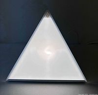 Front view of illuminated Luxor pyramid light therapy lamp