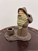 Front view of stoneware wizard figurine on wooden surface