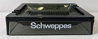 Side view showing Schweppes logo on smoky glass