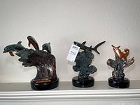Group of three Donjo marine sculptures on bases