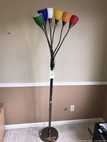 Full view of floor lamp standing upright, shades visible