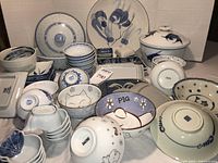 Overview of entire assortment showing tureen, platter, bowls, plates, trays