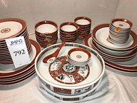 Entire dinnerware set showing plates, bowls, condiment dishes, large serving bowl and spoon