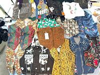 Overview of assorted novelty and reversible women’s vests spread out on surface