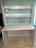 Front view of white desk and attached hutch