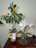 Entire lot showing kumquat tree, lily arrangement, and cat tray
