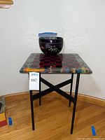 Glass chess board tabletop on stand with bowl displayed
