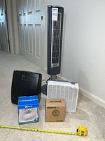 Group shot of all five items including Lasko tower fan, Carico purifier, Aries box fan, and boxed XGear and Beskar desk fans
