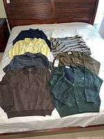 All seven garments laid out on bed