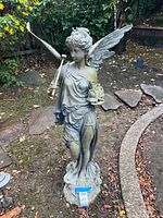 Front view of angel statue showing train and trumpet