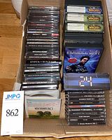 Full view of box with stacked jewel case games and boxed items