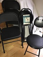 Group of all seven folding chairs nested together