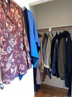 Closet rod with multiple coats in various colors and fabrics