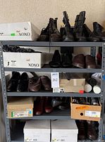 Full shelving unit showing multiple boxes, visible pairs of boots and shoes, aerosol cans