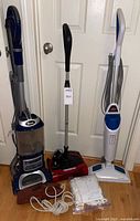 Shark upright vacuum, Oreck stick vacuum, Bissell steam mop, bundle of pads and cords