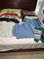 All sweaters and leg warmers arranged on bed