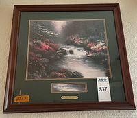 Full view of framed Thomas Kinkade print on wall