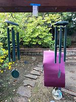 Both wind chimes hanging outdoors