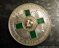 Full view of medal front showing inscriptions, enamel cross, gold thistle