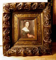 Front view of carved hardwood frame with portrait print