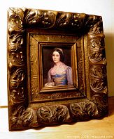 Front view showing ornate frame and portrait
