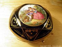 Top view showing hand painted scene and gold gilt decoration