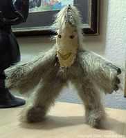 Front view of fur-covered Inuit doll showing carved face and limb structure
