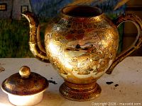 Teapot and sugar bowl showing gilt samurai scenes