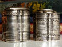 Front view of both engraved sterling boxes