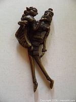 Full view of brass nutcracker showing both figures and overall shape