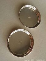 Both round sterling dishes showing overall design