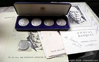 Coins in presentation case with menus and loose coin visible