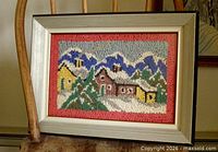 Front view of framed hooked wool rug showing full winter scene