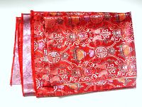 Folded red brocade fabric panel showing overall color and pattern