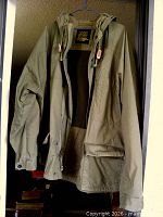 Full front view of khaki hooded jacket hanging