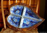 Full view of leaf-shaped tray showing blue glazed ceramic insert and carved wooden border